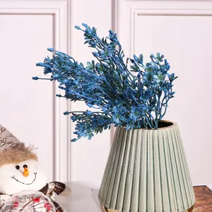 Artificial blue flower bouquet with green ribbed ceramic vase for home office interior decoration