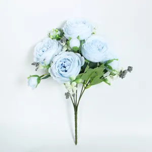 Detailed view of artificial blue rose and peony bouquet, showing petals, leaves, and stem structure.