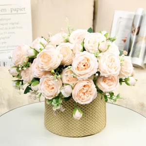 Beautiful artificial peony rose flower bouquet in woven pot for home table decor detail.