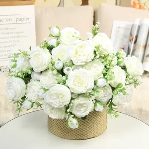 Detailed view of artificial white peony rose flower bouquet in woven pot for home decor.