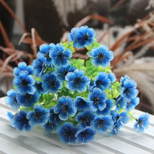 Artificial blue flower bouquet for home decoration, realistic floral arrangement detail.