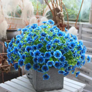 Close-up detail of blue artificial flower bouquet arrangement in a metal pot for home decor.