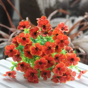Detailed close-up view of vibrant orange artificial flower bouquet for home decoration