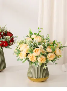 Detailed view of artificial yellow peony flower bouquet in green ceramic vase for home decor.