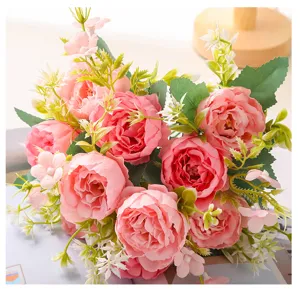 Close up of artificial pink peony bouquet with green leaves for home decoration and weddings.