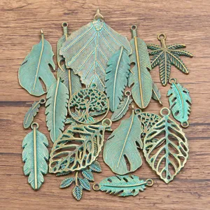 Close-up details of antique bronze patina alloy leaf feather charms for DIY jewelry making.