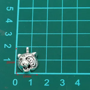 Detailed close-up of a silver-toned metal tiger head charm, perfect for DIY jewelry crafting.