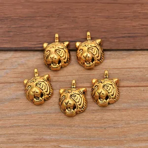 Antique gold tiger head pendant charms for DIY jewelry making, necklace and bracelet crafts.