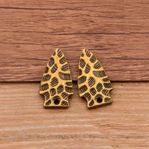 Close-up of alloy arrowhead pendants with hammered texture, perfect for DIY jewelry making.