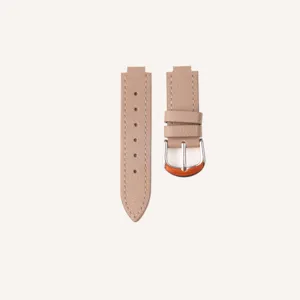 Detailed shot of a taupe leather watch strap with silver buckle and convex connector end.
