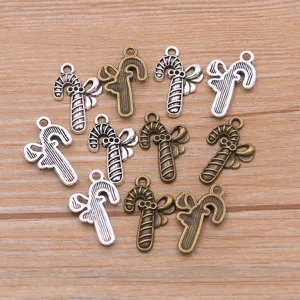 Detail shot of antique silver and bronze alloy candy cane bow charms for DIY jewelry making.