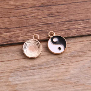 Detailed view of KC gold yin yang pendant, alloy enamel tai chi charm for DIY jewelry making.