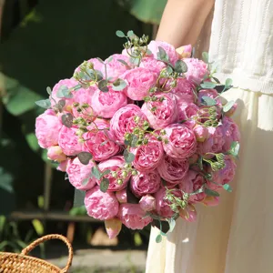 Close-up detail shot of artificial pink rose bouquet with eucalyptus leaves for home.
