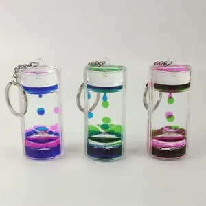 Creative dual-color liquid motion bubbler keychain, stylish oil drop hourglass keyring decor.