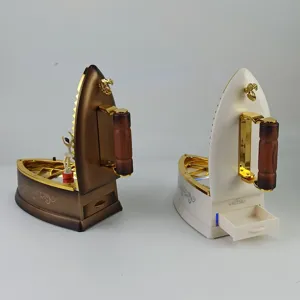 Boîte à musique à bijoux en forme de fer à repasser avec danseuse et tiroir de rangement.