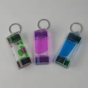 Detailed view of dual-color liquid motion bubbler keychains showing transparent acrylic drop design.
