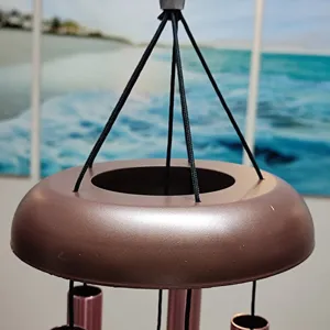 Detail view of the metal wind chime top hanging structure, perfect for outdoor garden decor.