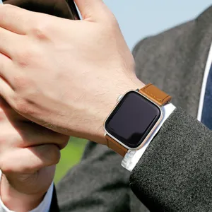 Leather watch strap detail showing premium brown genuine leather texture and metal buckle.