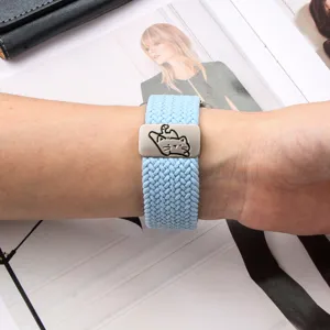 Detailed view of elastic nylon braided watch band featuring cute cat metal charm.