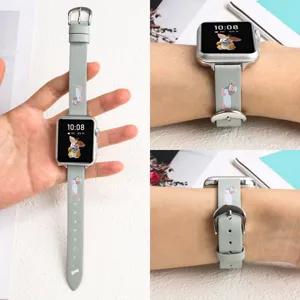 Grey leather apple watch strap detail showcasing cute dog pattern and silver buckle.