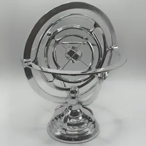 Detail closeup of silver metal armillary sphere desktop perpetual motion ornament model.