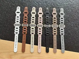 Replacement strap for Apple Watch featuring a unique triple-link design in multiple vibrant colors.