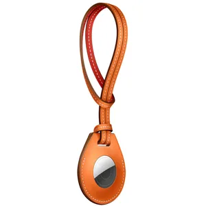 Orange leather strap loop protective case cover compatible with Apple AirTag tracker devices.