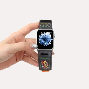 Denim apple watch strap detail showing colorful stitching and sport graffiti design for daily wear.