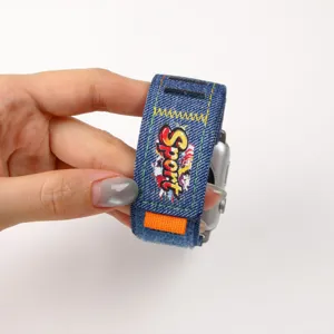 Graffiti denim watch strap compatible with Apple Watch, featuring secure velcro closure.