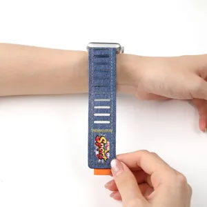 Denim smartwatch band compatible with Apple Watch, breathable slots and orange pull tab.
