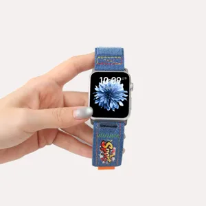Detail view of denim velcro watch strap with graffiti print for Apple Watch, stylish design.