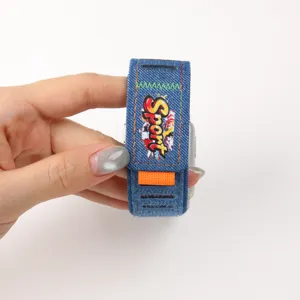 Denim watch band compatible with Apple Watch, stylish graffiti sport design with secure Velcro closure.