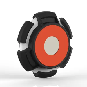 Close-up view of the magnetic AirTag protective case with black, white and orange details.