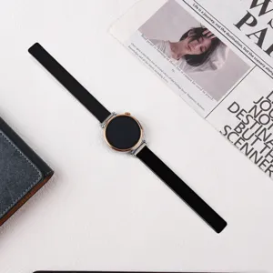 Detailed view of the elegant black leather smart watch strap with rose gold metallic dial.