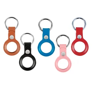 Detailed view of colorful leather protective cases with metal key rings for tracking devices.