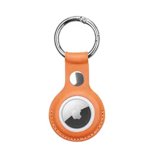 Detailed view of the orange leather AirTag keychain case, showing premium texture and secure fit.