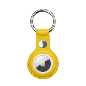 Detailed close-up of the bright yellow leather protective case for AirTag with metal ring.