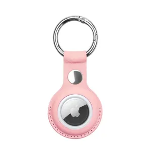 Pink leather AirTag case detail showing secure snap button closure and sturdy metal keyring.