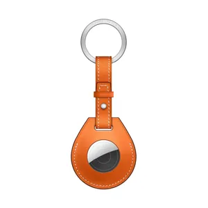 Orange leather AirTag protective case detail view, premium keychain design with metal ring.