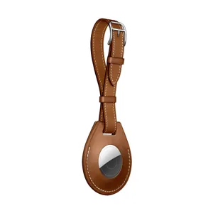Brown leather protective case and keychain compatible with Apple AirTag tracker accessory.