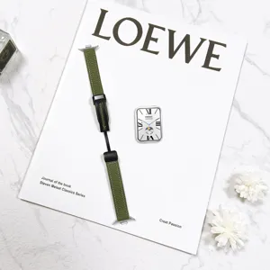 Green leather watch strap featuring folding clasp displayed on luxury marble background details