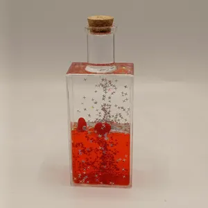 Decorative red liquid motion sensory bottle with star glitter and cork stopper for home desk decor