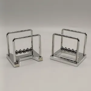 Detailed view of silver metal Newton cradle balance balls office desk decoration ornaments.
