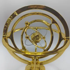 Gold armillary sphere desktop ornament, metal orbital model detail view, science decor item.