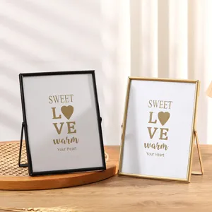 Metal picture frame detail shot, creative rectangular desktop photo display stand in black and gold.