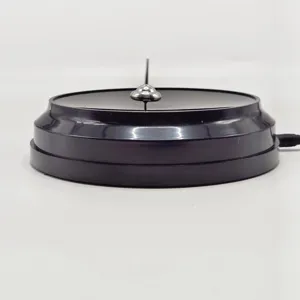 Detailed view of the USB powered kinetic spinning top toy placed on a black base.