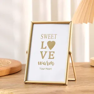 Gold metal photo frame desktop picture display stand with decorative insert card for home decor.