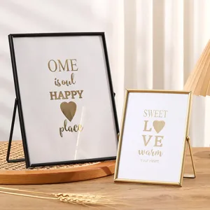 Metal picture frame tabletop decor set with geometric design and elegant glass stand display.