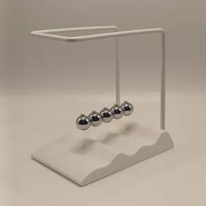 Closeup of the creative wave base Newton cradle with metal balls for desk decor gift.