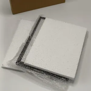 Detailed view of the metal picture frame packaging with protective styrofoam and bubble wrap.